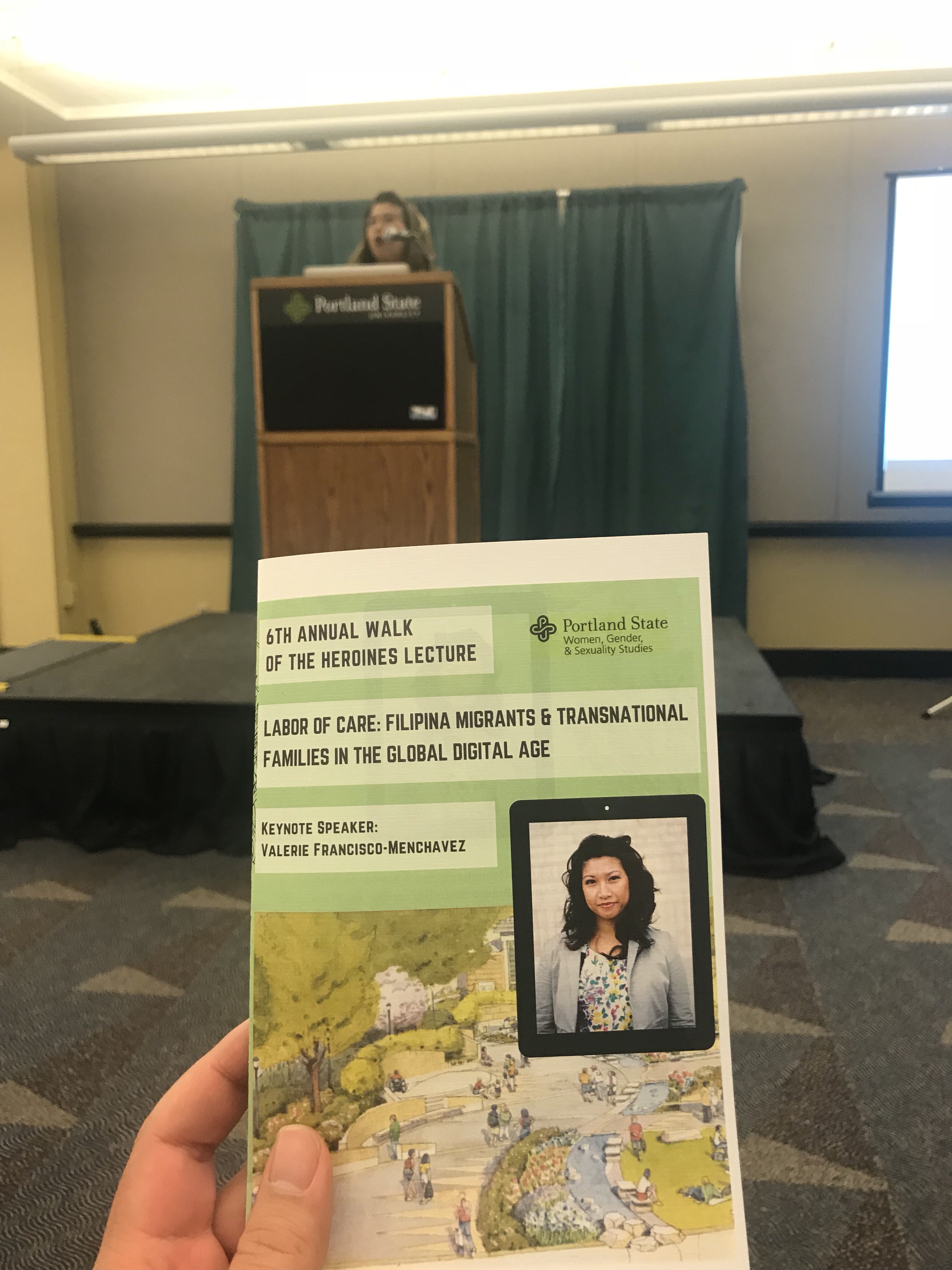 Photo credit: Patrick Villaflores Image description: Copy of the evening’s paper program in the foreground and VFM speaking in the background 
